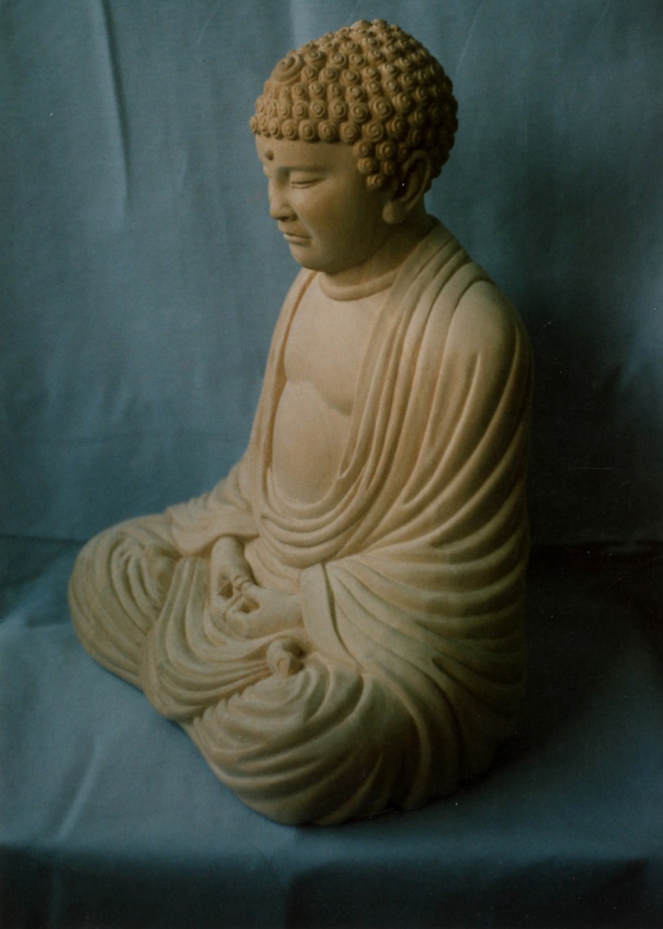 Buddha - side view - Buddha carved in wood for casting in stone
