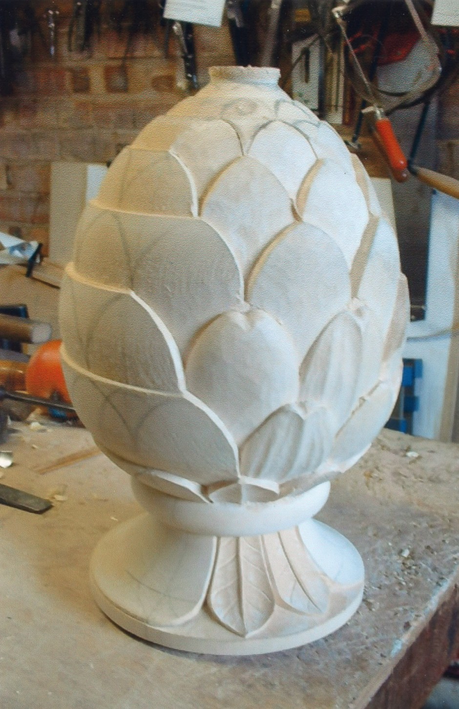 The basic leaf shapes are roughed out. - pineapple rough carved, carving rough work, pineapple carving